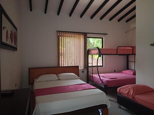a bedroom with two bunk beds and a window at hotel palma dorada in Doradal