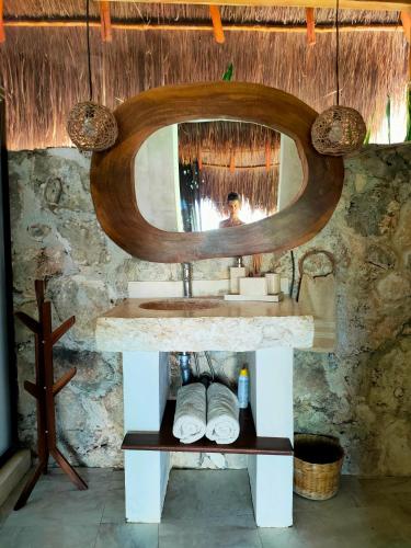 a bathroom with a sink and a mirror at Villa Ensueño, Lagoon Private Front in Bacalar