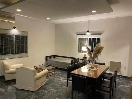 sala de estar con cama, mesa y sillas en Tu alojamiento en Santiago del Estero en Santiago del Estero