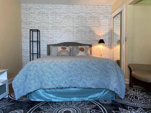 a bedroom with a bed and a brick wall at Cozy home, King bed, 3 bedrooms,close to downtown beaches towncenter in Jacksonville
