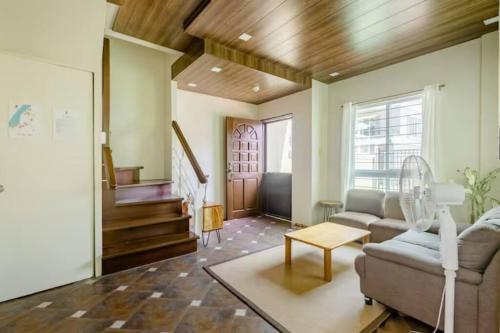 a living room with a couch and a table at Private Townhouse (Serenia Homestay) in San Juan