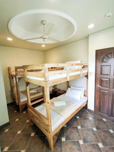 two bunk beds in a room with a ceiling at Private Townhouse (Serenia Homestay) in San Juan