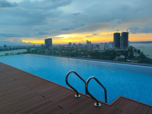 uma piscina no topo de um edifício com uma cidade em 902 Hareta Serviced Apartment em Phnom Penh