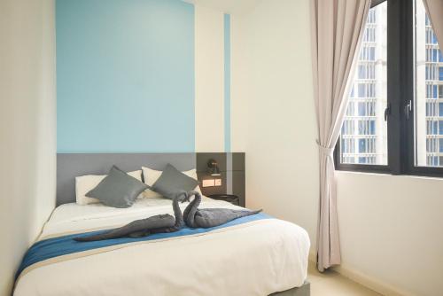 a bedroom with a bed with a large window at D'Pristine Theme Suite by Nest Home at LEGOLAND in Nusajaya