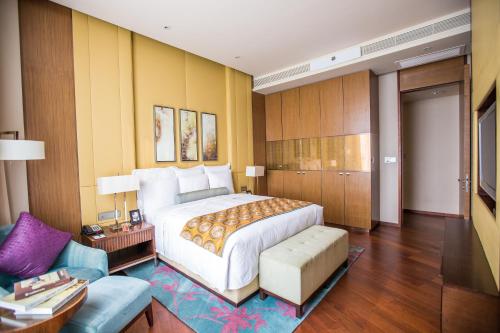 a bedroom with a large bed and a living room at Marriott Executive Apartment Tianjin Lakeview in Tianjin