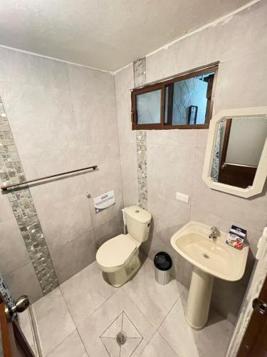 a bathroom with a toilet and a sink at Casa Halley #2 con vista al mar , Playas in Data de Posorja