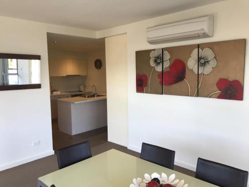 a dining room with a table and a kitchen at Wyndham Resort Torquay in Torquay