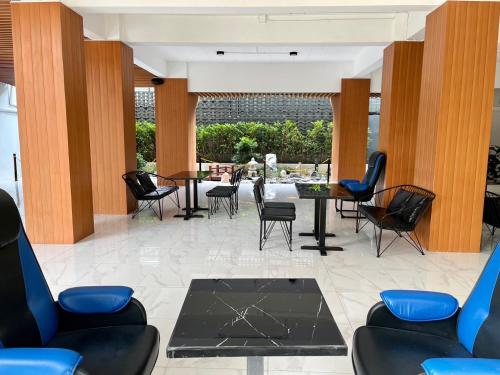 a lobby with chairs and a table with a view at Wesahh Homeplace in Khon Kaen