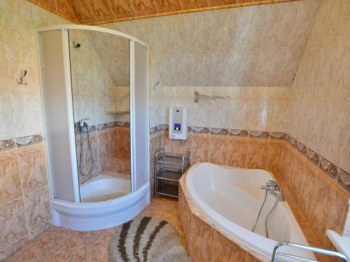 a bathroom with a tub and a shower and a sink at Holiday house with private garden, Jaros awiec in Jarosławiec