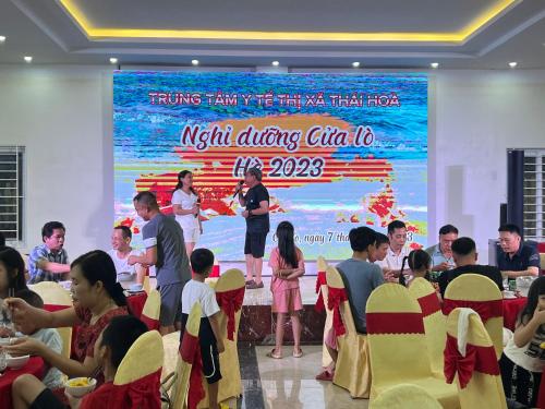 a group of people sitting in chairs in front of a stage at Khách sạn NHẬT MINH Cửa Lò in Cửa Lò