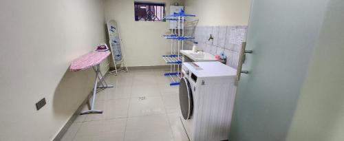 a hospital room with a sink and a refrigerator at EDIFICIO RENZO Apart in Tarija