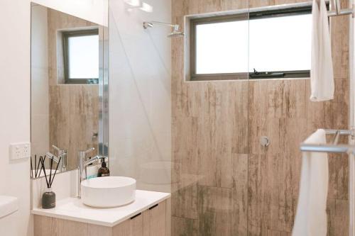 a bathroom with a sink and a shower at B e a c h H o u s e X I V in Bicheno