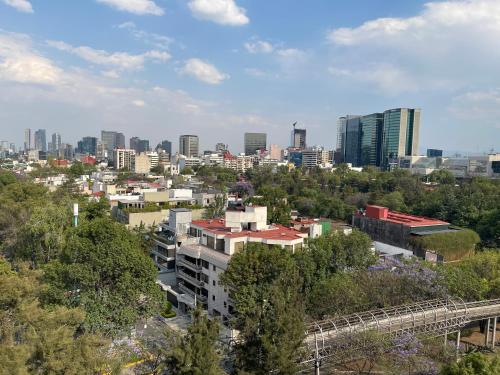 a cityscape of a city with a bridge and buildings at bnb2night Polanco-Apartments in Mexico City