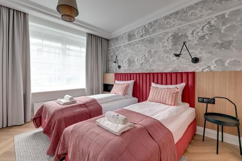a hotel room with two beds and a window at Lion Apartments - Havana Premium Family Stay in Sopot