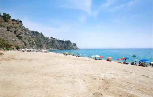 a group of people sitting on a beach with umbrellas at Amazing Home In Staletti With Wifi in Stalettì