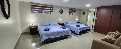 a hotel room with two beds and a couch at EDIFICIO RENZO Apart in Tarija