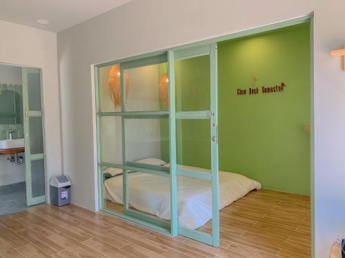 a room with a glass partition with a bed in it at Chon's Dock Homestay & Apartment For Lease in Phan Thiet