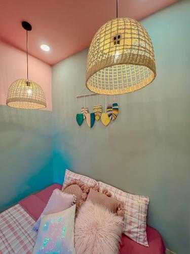a bedroom with two lamps and a bed with pillows at Chon's Dock Homestay & Apartment For Lease in Phan Thiet