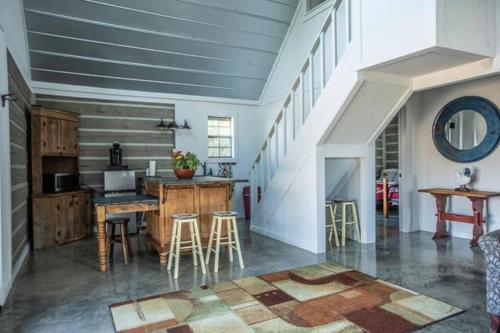 a kitchen with a table and chairs in a room at Saddle Creek Cabins in Roznov