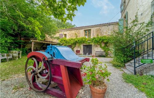 an old tractor sitting in front of a building at Nice Home In Chalabre With Wifi in Chalabre