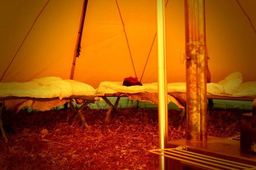 a room with two beds in a tent at Wildlife camp In a Nordic tipi in Olofstorp