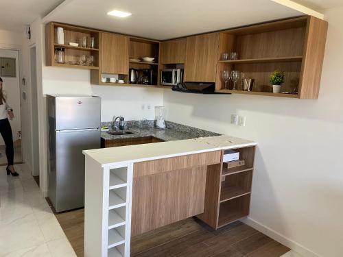 a kitchen with a refrigerator and a counter top at Bello monoambiente a metros del aeropuerto in Colonia Mariano Roque Alonso