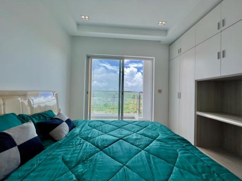 a bedroom with a large bed with a large window at Sihanouk City View Condominium in Sihanoukville