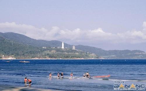 a group of people in the water at the beach at Hiên lương hotel &Apartment in Danang
