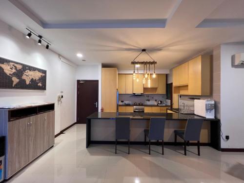 a kitchen with a large island in a room at Super Comfy BIG SPACE Condo In Imperial Suites Boulevard Mall in Kuching