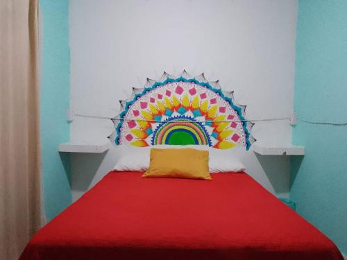 a room with a bed with a rainbow on the wall at Casita del Árbol in Mexico City