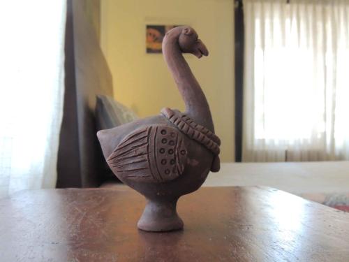 a statue of a bird sitting on top of a table at Sublime Homestay in Bhubaneshwar