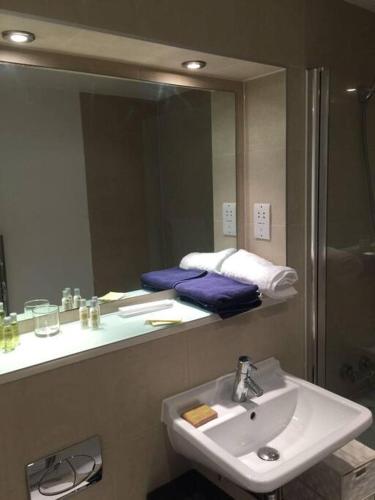 a bathroom with a sink and a mirror at Avalon apartment city center of brighton & hove in Brighton & Hove