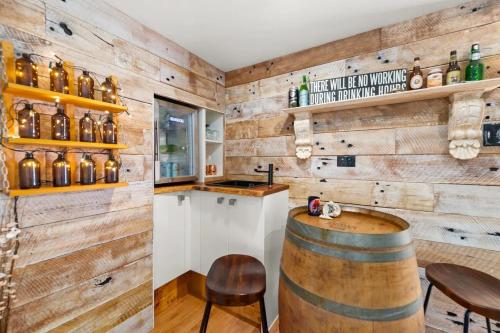 a wine tasting room with wooden walls and a barrel at Fingal Pines Getaway, Apartment in Fingal Bay