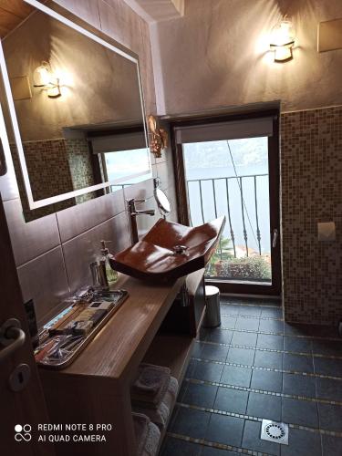 a bathroom with a wooden sink and a mirror at Private Romantic Wellness Lake View Retreat- Whirlpool Hammam Spa e Piscina panoramica in Maccagno con Pino e Veddasca