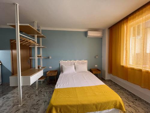 a bedroom with a bed with a yellow blanket at Summer H. Studio Sunny Beach in Sunny Beach