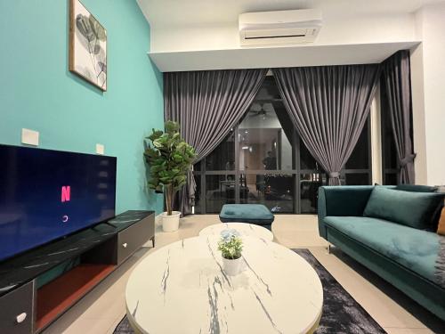 a living room with a couch and a table at Grand Medini Residence by Luxecocoo CK Legoland in Nusajaya