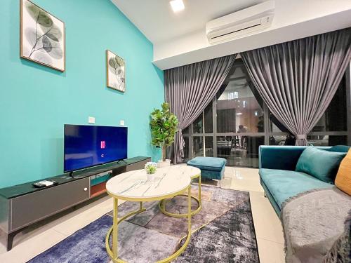 a living room with a couch and a tv and a table at Grand Medini Residence by Luxecocoo CK Legoland in Nusajaya
