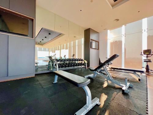 a fitness room with a gym with tread machines at Grand Medini Residence by Luxecocoo CK Legoland in Nusajaya