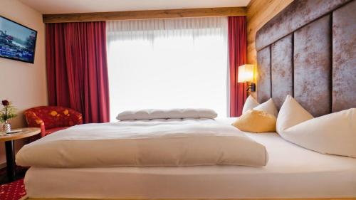 Postel nebo postele na pokoji v ubytování Kohlerhof - 4 Star Wellness & Active Hotel