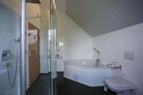 a bathroom with a shower and a tub and a toilet at Ferienhaus Erna in Doberlug-Kirchhain