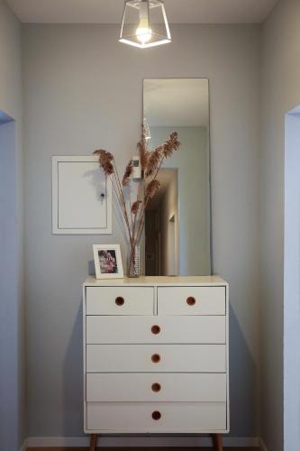 a dresser with a mirror on top of it at Ferienhaus Erna in Doberlug-Kirchhain