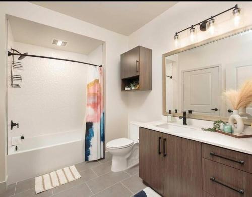 a bathroom with a shower and a toilet and a sink at Huge 2bd Apt Near Disneyland &Anaheim Conv Center 3Tofv in Anaheim