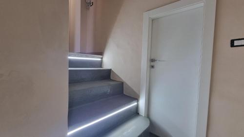 a staircase in a room with a door and some stairs at ILBaccone23 in Mesagne