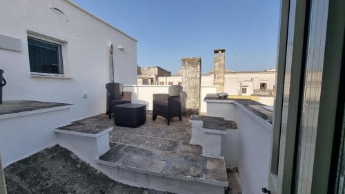 a balcony with two chairs and a view of a building at ILBaccone23 in Mesagne