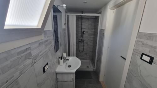 a small bathroom with a sink and a shower at ILBaccone23 in Mesagne