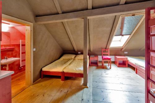 a small bedroom with a bed in a attic at Ekocentrum DOTEK in Horní Maršov