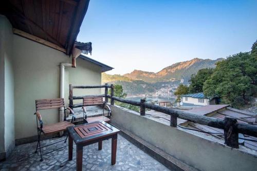 a bench on the balcony of a building with a view at Villa Bliss Nest in Nainital