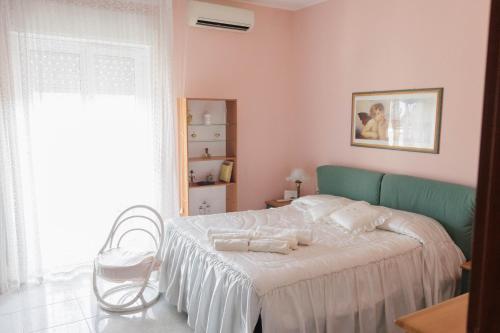 a bedroom with a bed with a chair and a window at Perle Rare di Sicilia in Sortino