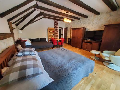 a living room with a large bed and a couch at Pensiunea Casa Dacilor in Podeni