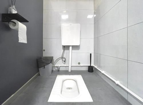 a bathroom with a white toilet in a stall at Sifang Space Hostel Xi'an - Xi'an TIYUCHANG metro station Line2 in Xi'an